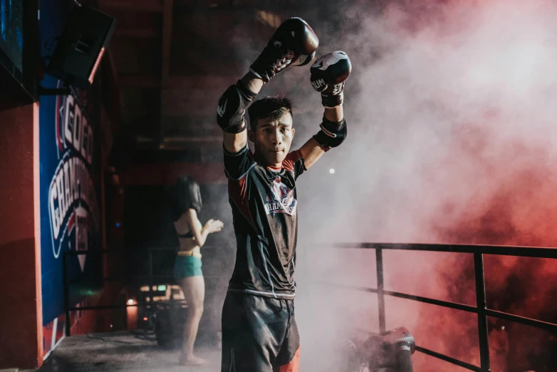 a man holding a boxing glove up in the air, a portrait, pexels contest winner, shin hanga, in an arena pit, cinematic full body shot, ninja warrior, proud looking