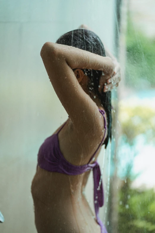 a woman in a purple bikini standing in the rain, unsplash, side profile view, showers, window ( rain ), cut out