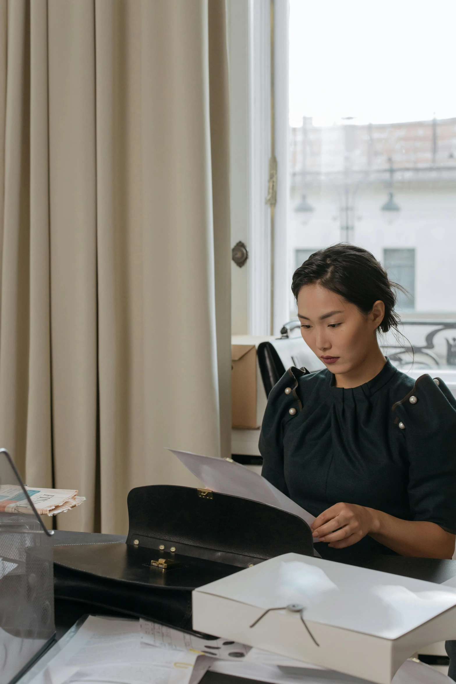 a woman sitting at a desk in front of a laptop computer, by Ruth Jên, pexels contest winner, li bingbing, writing on a clipboard, julia sarda, wearing business casual dress