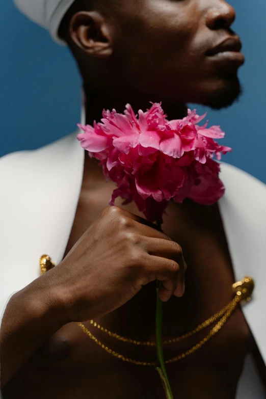 a close up of a person holding a flower, an album cover, inspired by Robert Mapplethorpe, romanticism, wearing a gold chain, man is with black skin, peony, prideful