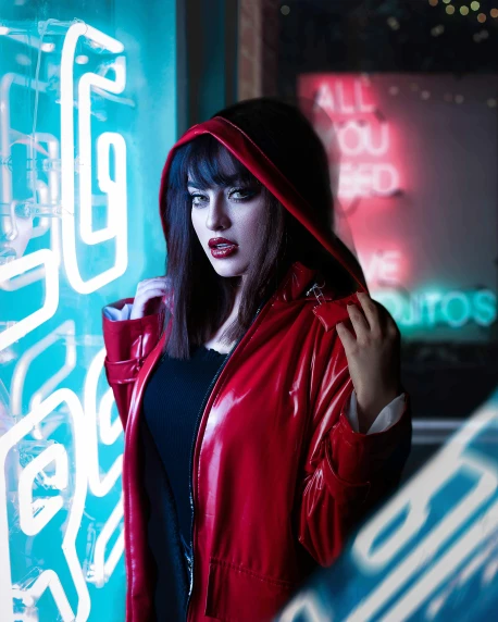 a woman standing in front of a neon sign, cyberpunk art, inspired by Elsa Bleda, wearing a scarlet hoodie, kat dennings, gothic jacket, woman vampire