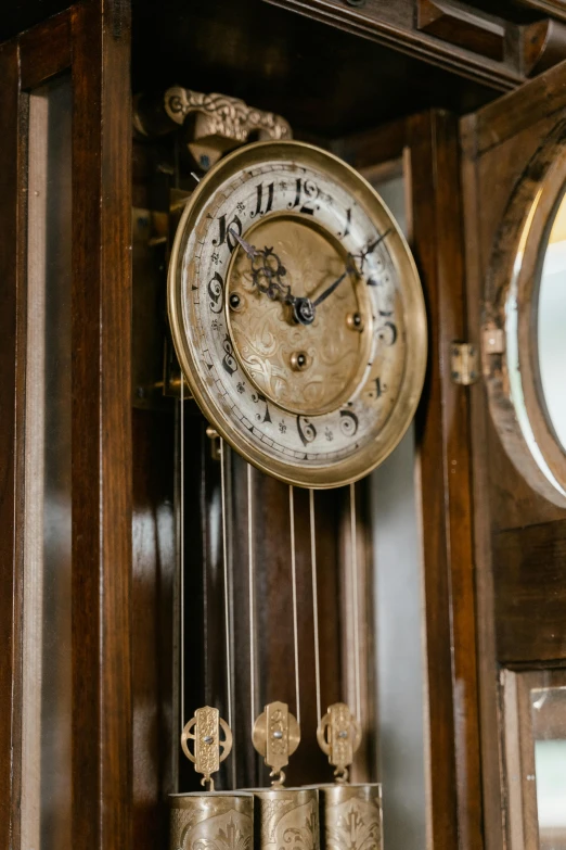 a close up of a clock on a wall, arts and crafts movement, thumbnail, the grand steampunk piano, 1 9 2 0 s room, brown
