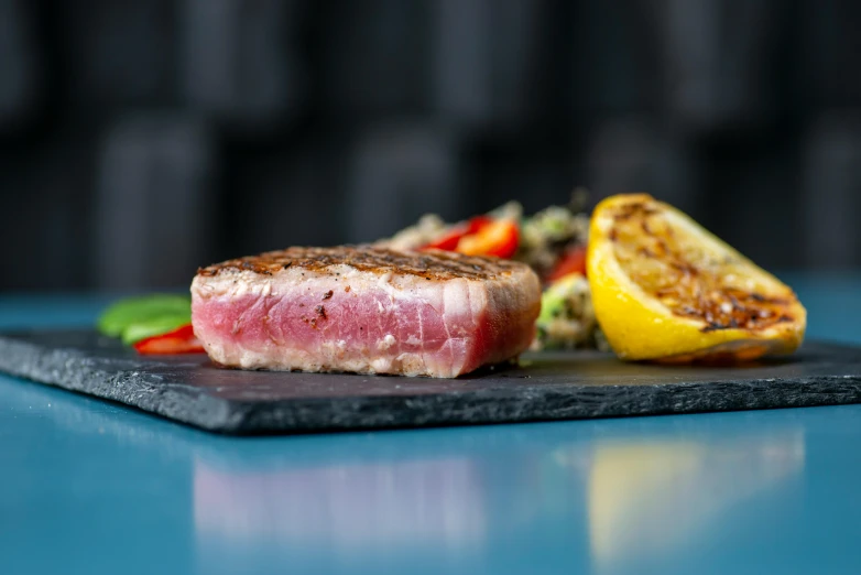 a piece of meat sitting on top of a cutting board, by Daniel Seghers, pexels contest winner, on the ocean, steak, multicoloured, sideview