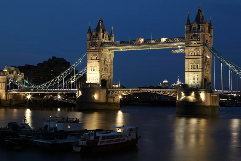 the tower bridge is lit up at night, pexels contest winner, thumbnail, enhanced photo, boat, simple