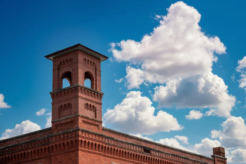 a large brick building with a clock tower, inspired by Robert Bechtle, pexels contest winner, renaissance, tall fluffy clouds, neo norilsk, smithsonian museum, thumbnail