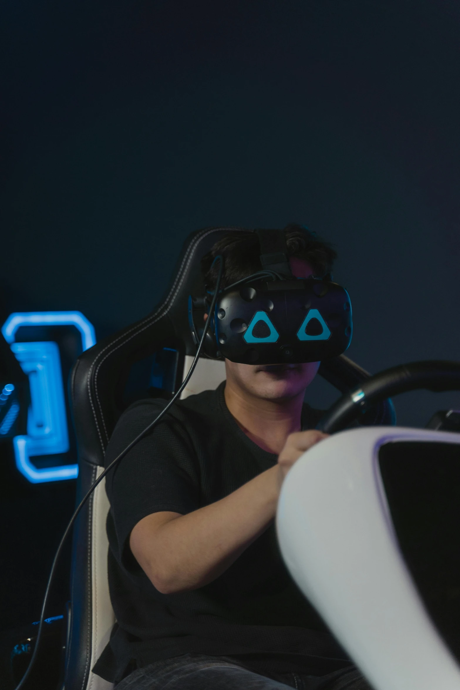 a man sitting in a chair wearing a virtual reality headset, alien racing drivers, pitch black room, avatar image, square