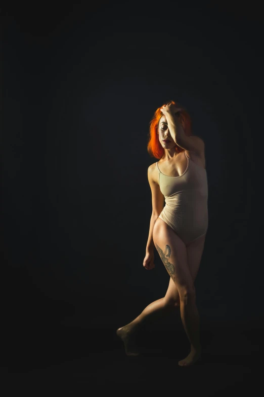 a woman in a white bodysuit standing in the dark, a portrait, by Andrew Stevovich, art photography, young redhead girl in motion, studio medium format photograph, [ realistic photography ], orange body