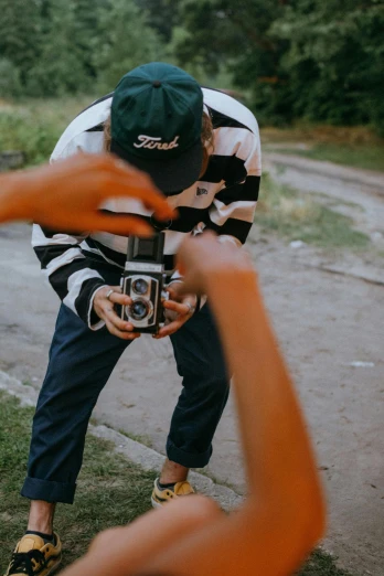 a man taking a picture of another man with a camera, pexels contest winner, visual art, crawling towards the camera, streetwear, old style photo, drone photograpghy