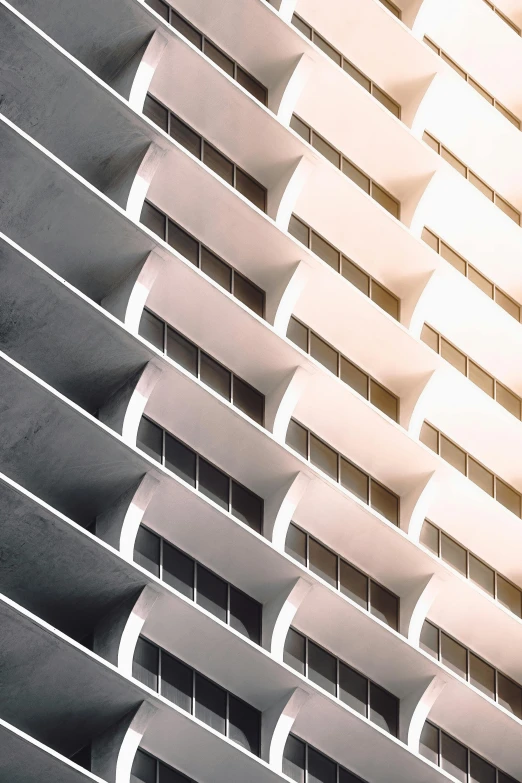 a tall white building with many windows and balconies, a digital rendering, unsplash, sunfaded, ezra stoller, balconies, light and dark