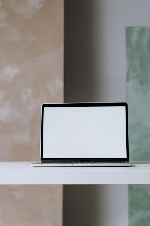 a laptop computer sitting on top of a white desk, by Carey Morris, minimalist structure, glowing screen, no - text no - logo, medium close-up shot