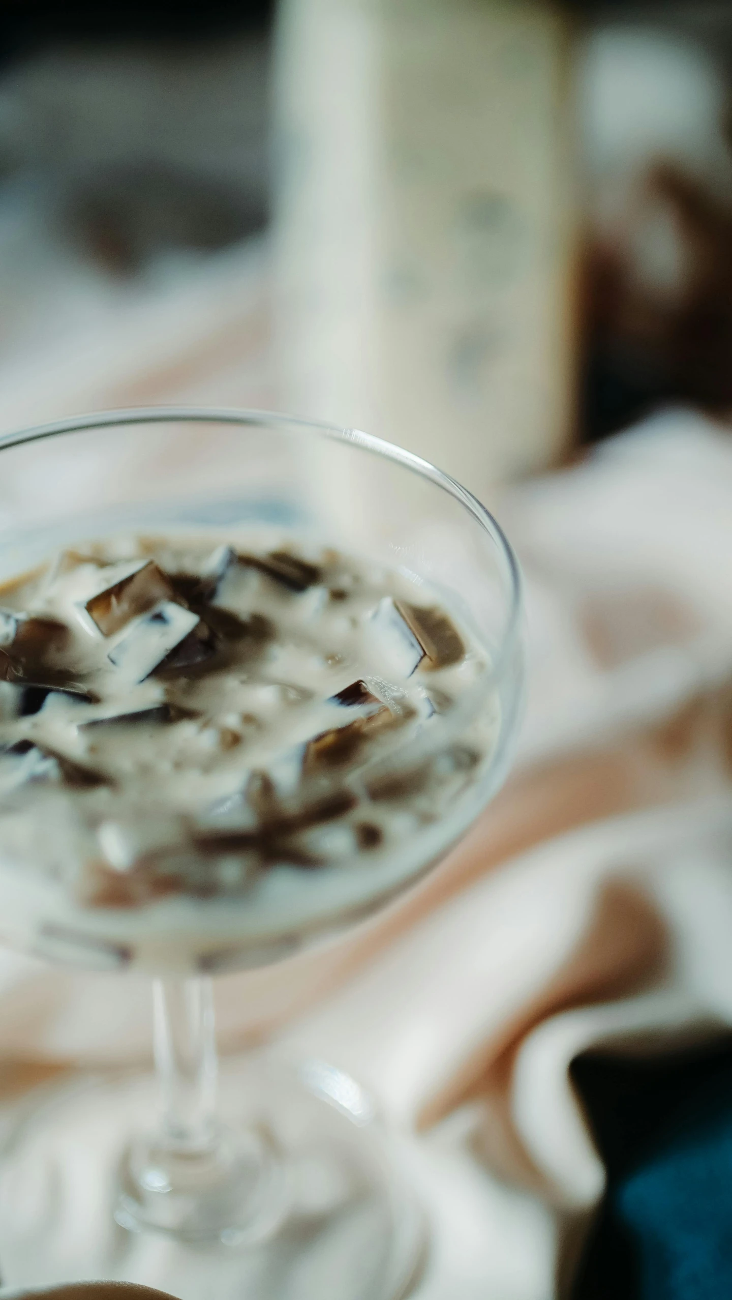 a close up of a drink in a glass on a table, inspired by Ndoc Martini, unsplash, mingei, made of mushrooms, soey milk, square, thumbnail