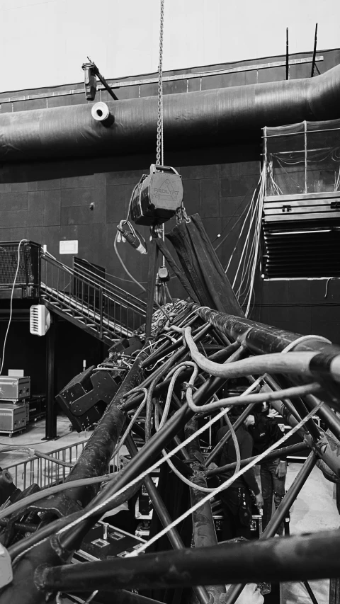 a black and white photo of a pile of wires, fluxus, big telescope in front, sitting in a crane, theatre equipment, ( ( photograph ) )