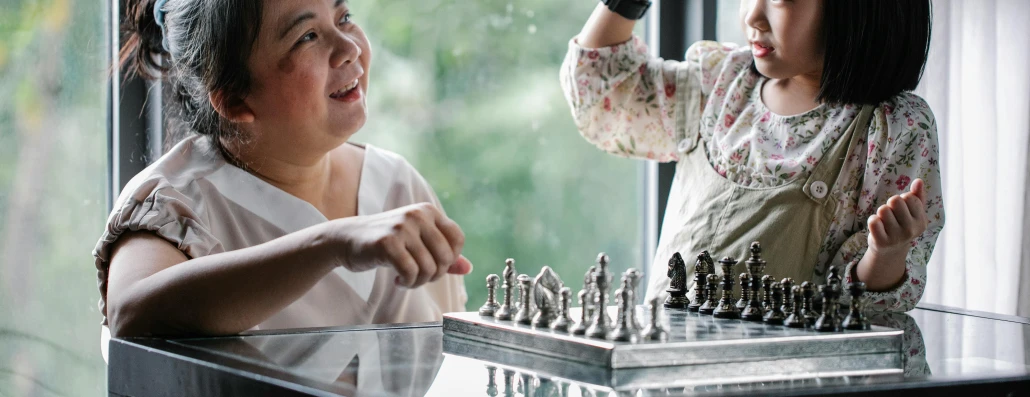 a woman and a little girl playing a game of chess, pexels contest winner, process art, tabletop model, thumbnail, engraved, joy ang