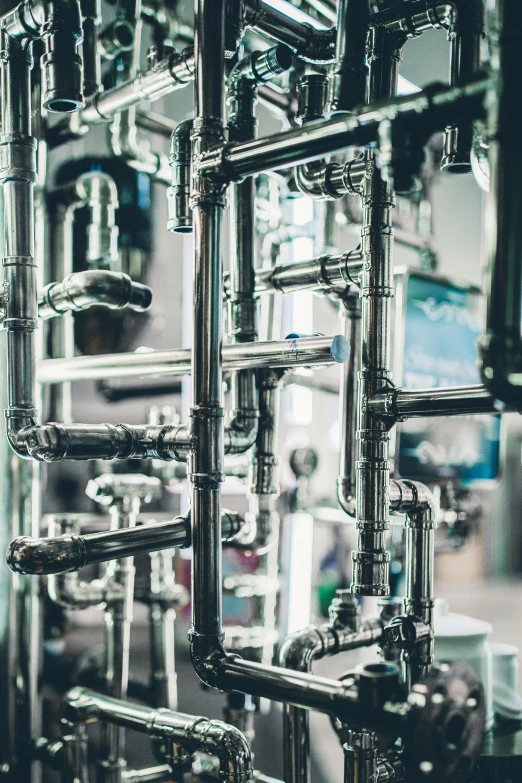 a bunch of pipes that are next to each other, by Jakob Gauermann, pexels contest winner, process art, high technology inplants, taps with running water, alchemy laboratory, stainless steel