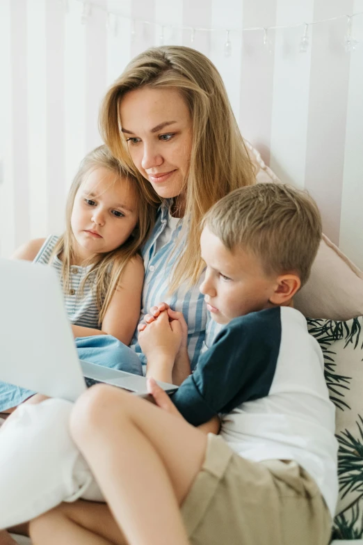 a woman and two children sitting on a bed with a laptop, profile image, casual playrix games, thumbnail, high-quality photo