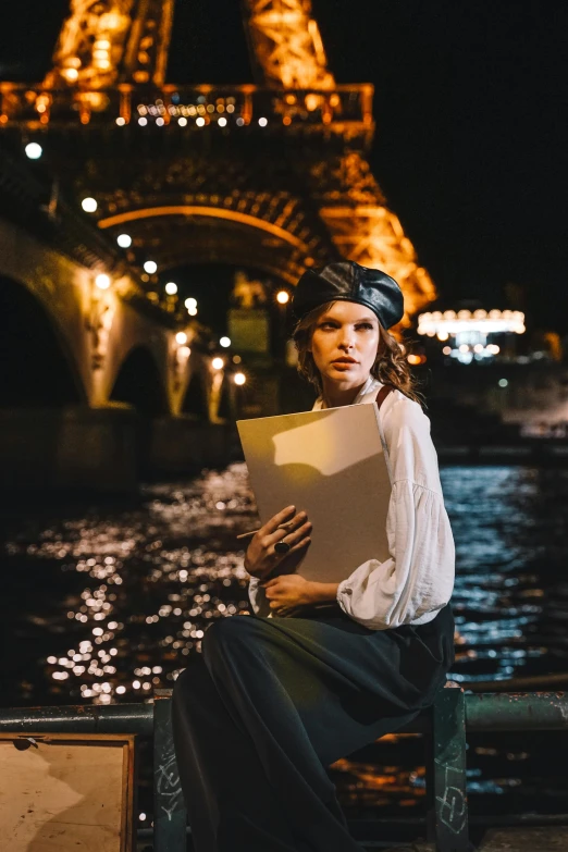 a woman sitting on a bench in front of the eiffel tower, a portrait, pexels contest winner, renaissance, floating lights, holding a giant book, wearing a beret, sitting near a river