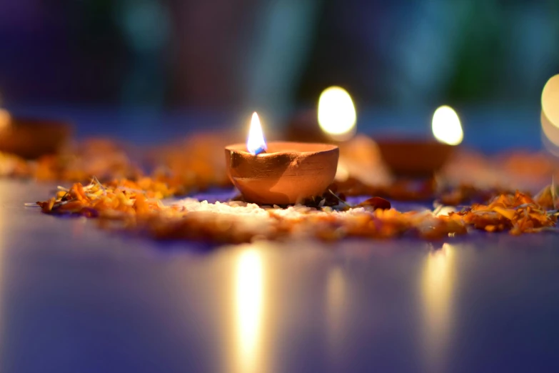 a group of candles sitting on top of a table, light and space, hindu ornaments, avatar image