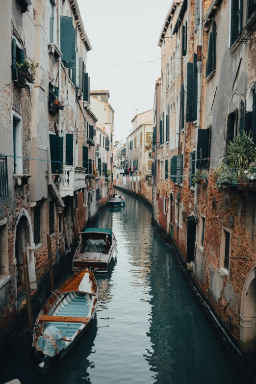 a couple of boats that are in the water, pexels contest winner, renaissance, narrow and winding cozy streets, gif, 2022 photograph, grain”