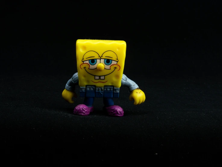 a close up of a toy on a black surface, a character portrait, pexels, pop art, spongebob squarepants, full body character, cube, lumpy skin