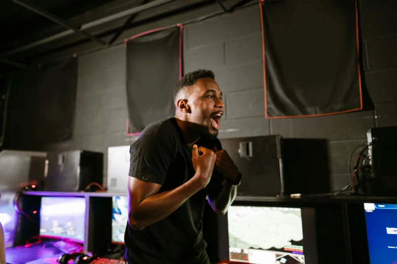 a man standing in front of a bunch of monitors, pexels contest winner, happening, : kendrick lamar, mutahar laughing, gaming room, happy with his mouth open