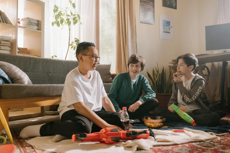 a group of people sitting on the floor in a living room, nerf or nothing, profile image, toy commercial photo, shot on 85mm