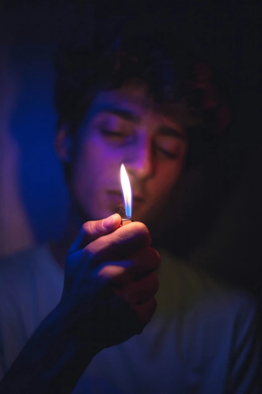 a man holding a lit candle in his hand, a portrait, by Niko Henrichon, pexels, teenage boy, smoking a blunt, instagram photo, contain