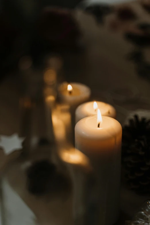 a group of lit candles sitting on top of a table, profile image