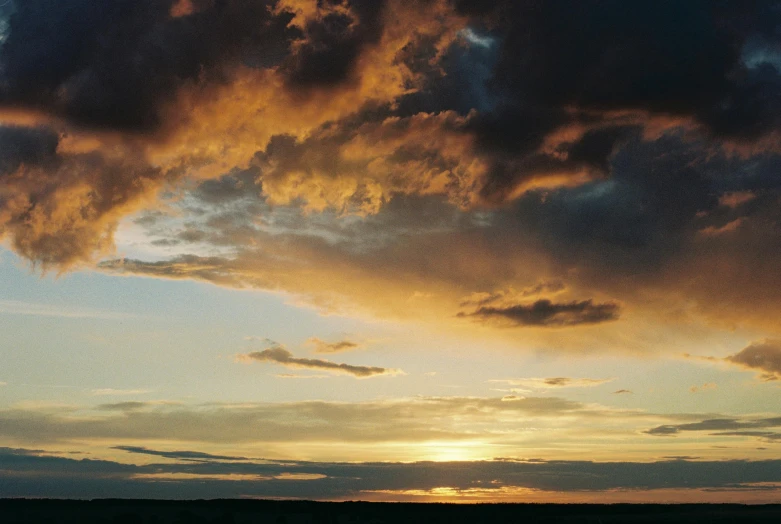 a large body of water under a cloudy sky, an album cover, unsplash, romanticism, beautiful new mexico sunset, ((sunset)), shot on hasselblad, thunderclouds