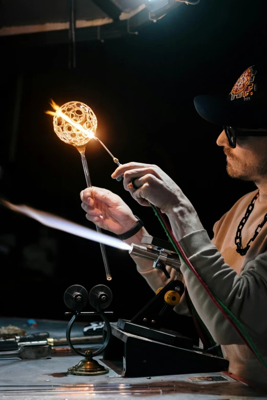 a man that is holding some kind of thing in his hand, trending on pexels, kinetic art, glass flame, smoking soldering iron, shades, light source from the left