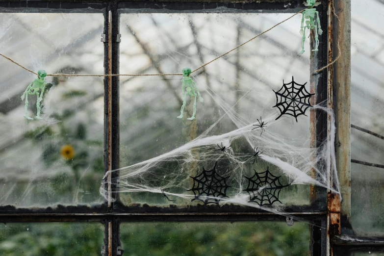 a bunch of spider webs hanging from a window, temporary art, painted metal and glass, exclusive, candy decorations, profile image
