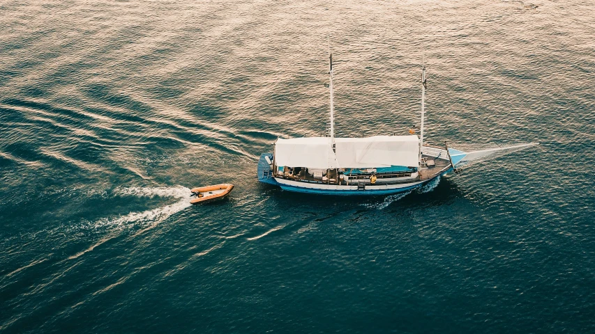 a boat in the middle of a body of water, on a yacht at sea