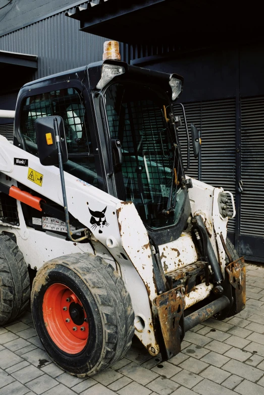 a white ski - door parked in front of a building, reddit, arbeitsrat für kunst, heavy machinery, close-up photo, half cat, farming