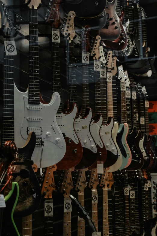 a bunch of guitars hanging on a wall, zoomed in, melbourne, the store, shot with sony alpha