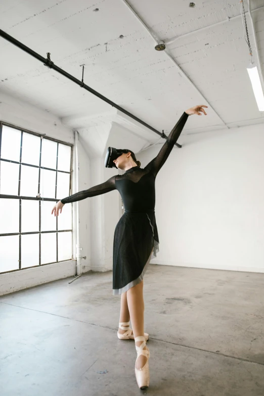 a woman in a black dress is dancing, by Liza Donnelly, unsplash, arabesque, with shoulder pads, contemporary fashion shoot, lachlan bailey, longque chen