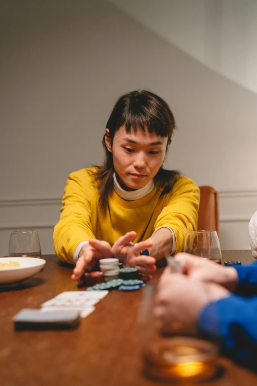 a couple of people that are sitting at a table, inspired by Fei Danxu, pexels contest winner, playing games, woman holding another woman, lee madgwick & liam wong, gameplay still