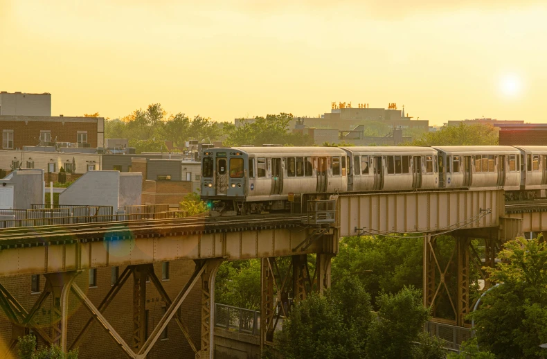 a train that is going over a bridge, by Washington Allston, unsplash, renaissance, golden hour in manhattan, monorail, uncropped, 2000s photo