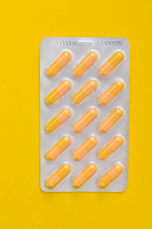 pills in a blister pack on a yellow background, by artist, pexels, back facing, orelsan, marc newson, multiple stories