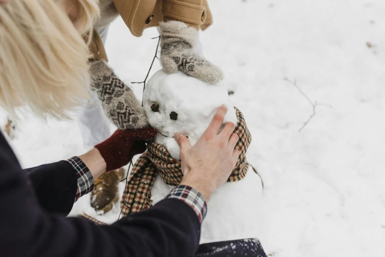 a woman is making a snowman in the snow, pexels contest winner, 😭🤮 💔, avatar image, realistic cloth puppet, handsome