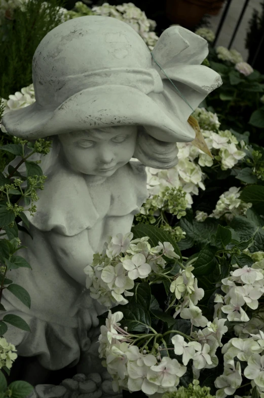 a statue of a woman in a hat surrounded by flowers, inspired by Margaret Brundage, concrete art, medium gargoyle soft light, looking sad, pale greens and whites, young child