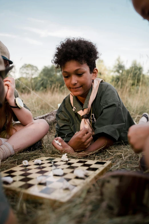 a group of people playing a game of checkers, a portrait, trending on unsplash, boy scout troop, safari, low quality photo, glamping