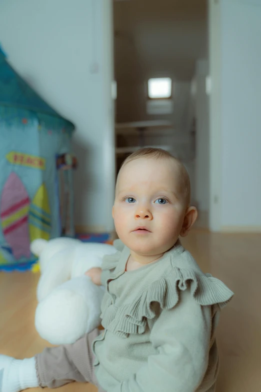 a baby sitting on the floor with a stuffed animal, a picture, walking towards camera, uplit, portrait of sanna marin, taken in the late 2010s