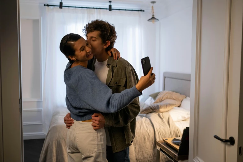 a man and a woman kissing in a bedroom, trending on pexels, taking a selfie, bisexual lighting, two men hugging, smartphone photo