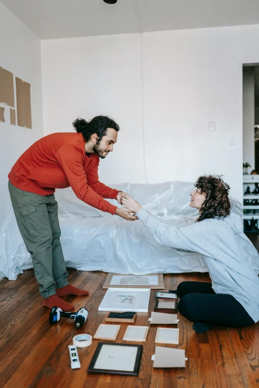 a couple of people that are in a room, visual art, reaching out to each other, flattened, promo image, apartment of an art student