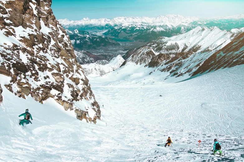 a group of people riding skis down a snow covered slope, pexels contest winner, snowy craggy sharp mountains, photo of zurich, thumbnail, canyons