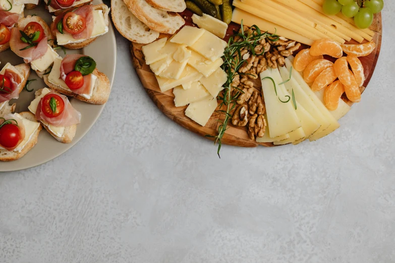 a couple of plates of food on a table, pexels, renaissance, background image, cheeses, super high resolution, thumbnail