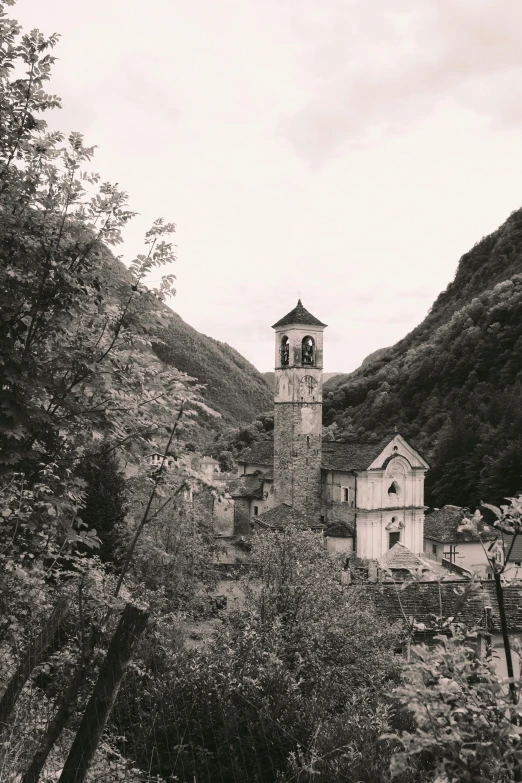 a black and white photo of a church in the mountains, romanesque, sepia colors, tiny village, autumnal, holy