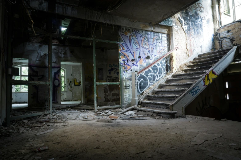 a staircase in an abandoned building with graffiti on the walls, an album cover, inspired by Elsa Bleda, pexels contest winner, ruins around, an abandoned old, bunker, inside a grand