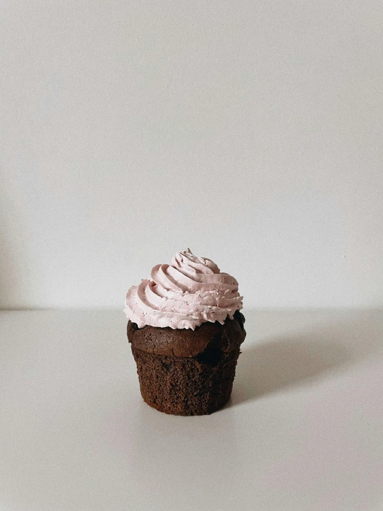 a cupcake sitting on top of a white table, by Robbie Trevino, profile image, ((purple)), food photograph, 8k))