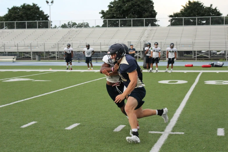 a group of young men playing a game of football, a photo, reddit, 8k octan photo, helmet on, structure : kyle lambert, athletic footage