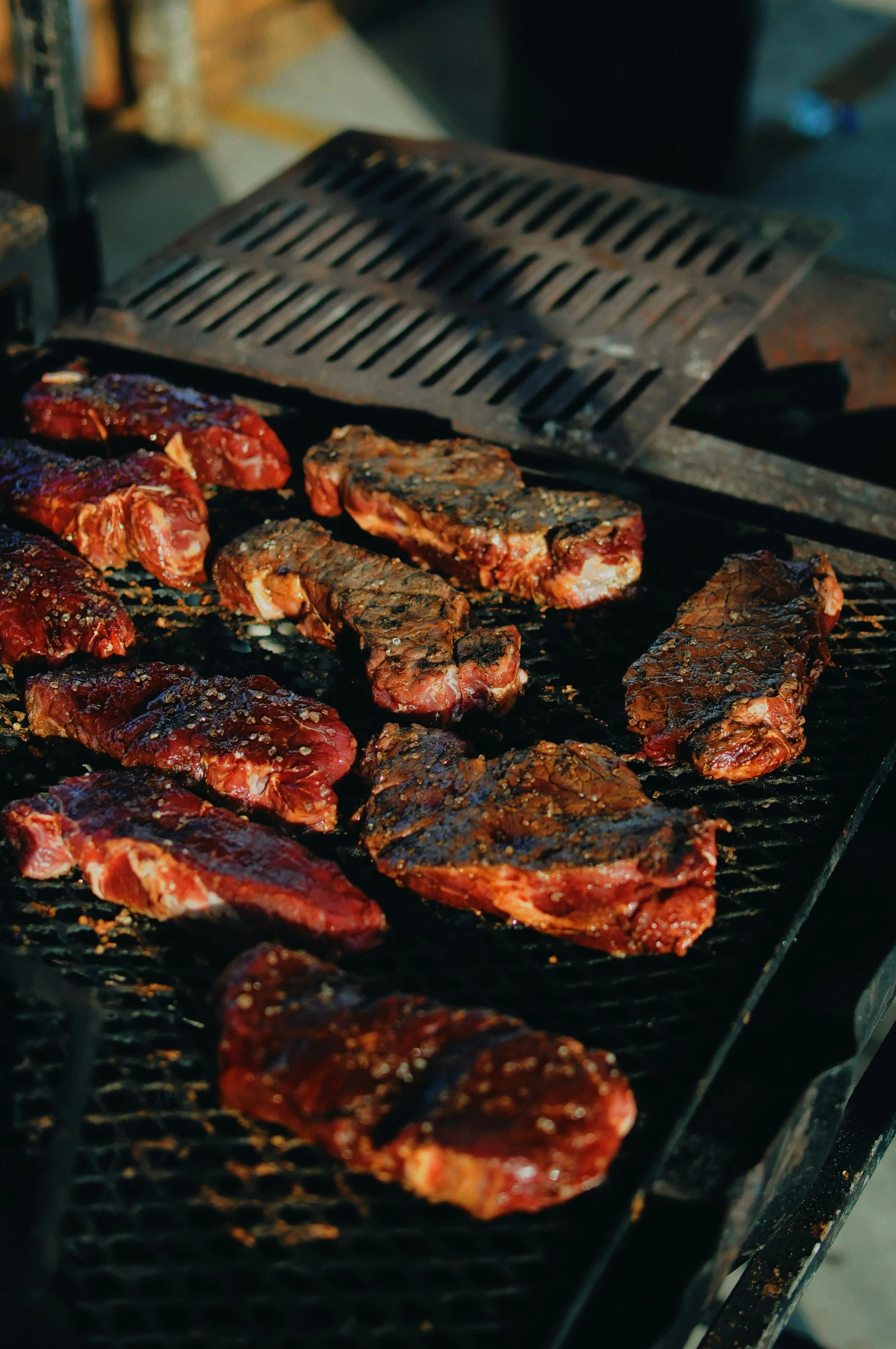 a bunch of steaks are cooking on a grill, pexels contest winner, dark skinned, bottom body close up, full scene, australian